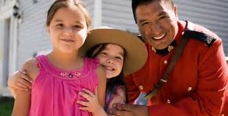 RCMP officer with girls smiling